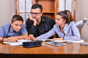 The boy and the girl are learning with the teacher