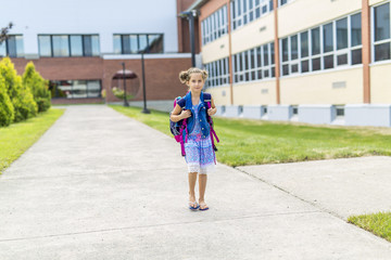Fototapeta na wymiar Great Portrait Of School Pupil Outside Classroom Carrying Bags