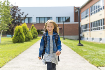 Great Portrait Of School Pupil Outside Classroom Carrying Bags