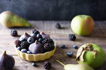 Seasonal fruits on wooden background.
