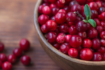 Cowberry, Grapeshot, Red Bilberry, Red Whortleberry,Mountain Cranberry,Lingonberry in bowl .Wooden background.