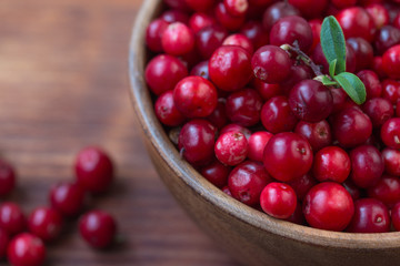 Cowberry, Grapeshot, Red Bilberry, Red Whortleberry,Mountain Cranberry,Lingonberry in bowl .Wooden...