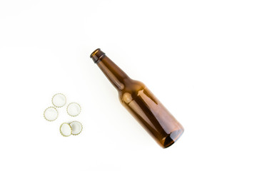 Empty Beer Bottle With Caps Next To It On White Background
