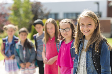 Great Portrait Of School Pupil Outside Classroom Carrying Bags