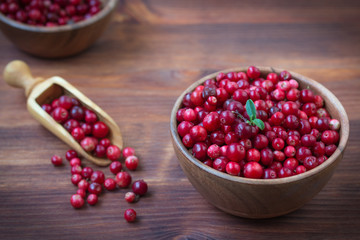 Cowberry, Grapeshot, Red Bilberry, Red Whortleberry,Mountain Cranberry,Lingonberry in bowl .Wooden background.