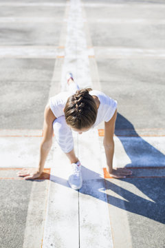 An athletic woman stretching outside