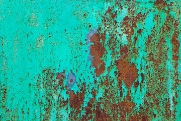Old metal green painted background with streaks of rust.