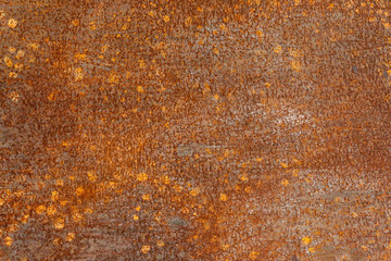 Old metal orange painted background with streaks of rust.