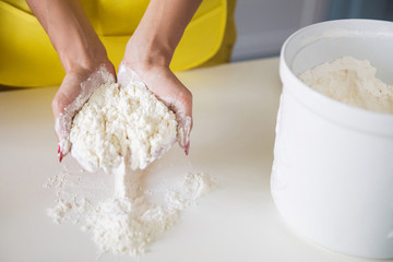 Photography of the flour in hands of cook woman