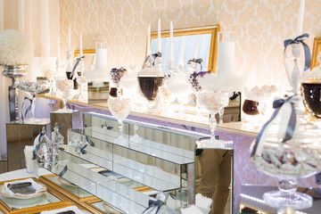 Delicious and tasty dessert table with cupcakes shots at reception closeup