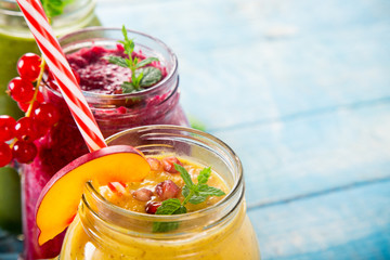 Healthy fresh smoothies with ingredients on old wooden table.