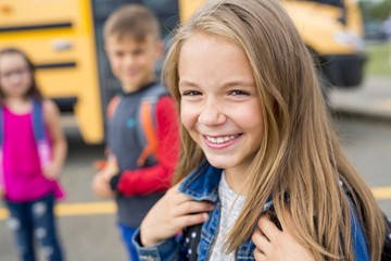 Great Portrait Of School Pupil Outside Classroom Carrying Bags