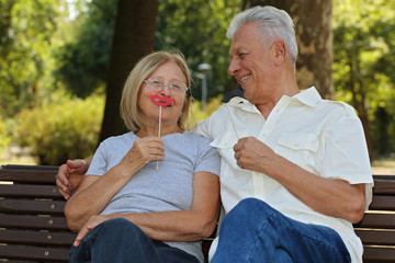 Happy elderly couple having fun outdoors . Healthy and Active Senior Lifestyle. Love, tenderness, togetherness concept