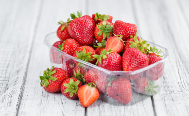 Portion of Strawberries on wooden background, selective focus