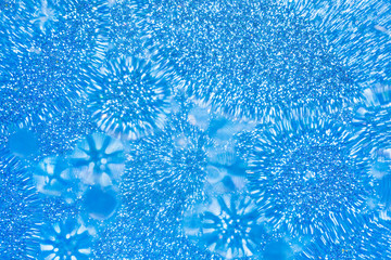 Abstract liquid bokeh or glitter lights  blue  background. Circles and defocused particles. Design template