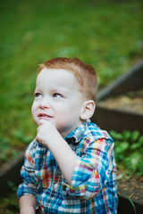 Redhead Boy Sitting and Thinking