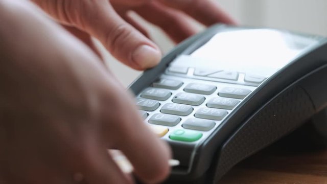 Close-up shot of person using credit card for mobile payment