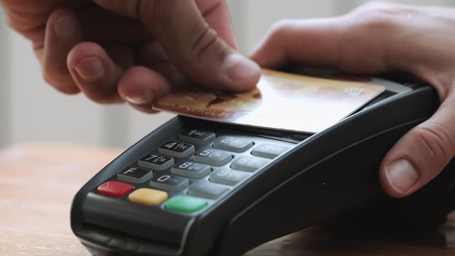 Close-up shot of person using mobile payment PayPass.