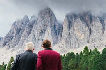 Fototapeta premium Young man and older man admiring view of Dolomite mountains in South Tyrol / Alto Adige, Italy