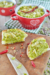 Cream of stuffed split peas with sauce of olive oil and fried onions, spread on bread slices.