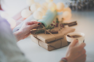 Woman sitting on the desk with christmas gift box