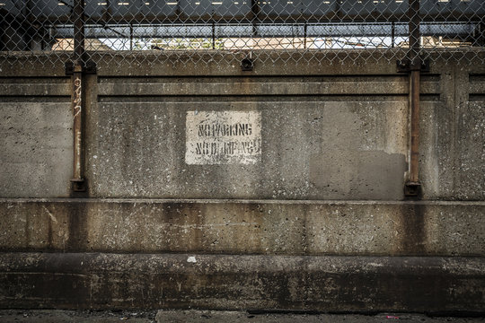 Grungy wall protecting urban subway tracks