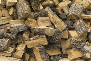 Pile of logs of firewood , selective focus and full frame photo