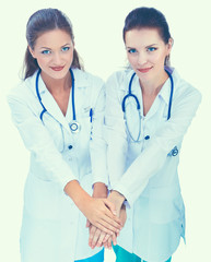 Doctors and nurses stacking hands. Isolated on white background