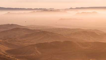 Fototapeta na wymiar hot air balloons over desert dunes, Sossusvlei, Namibia