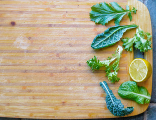 Leafy greens on cutting board, copy space