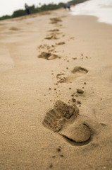 Fototapeta na wymiar Footprints in the Sand