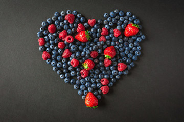 Heart shape assorted berry fruits on white background. Flat lay image. Blueberries, raspberry and strawberry
- 171248186
