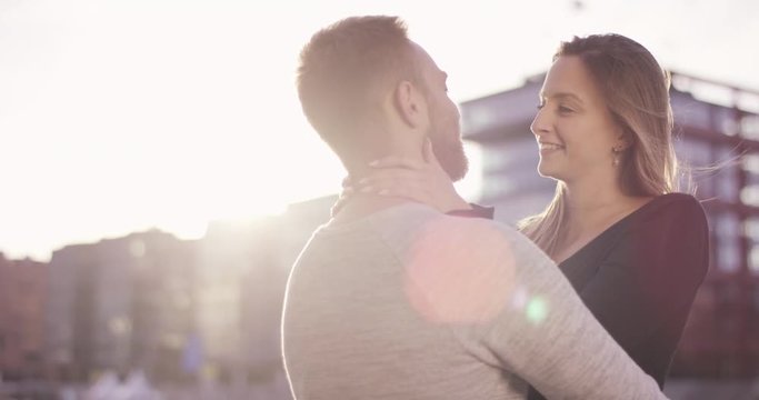 Young couple cuddling in sunset