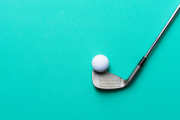 golf ball and golf club on green background - obrazy, fototapety, plakaty