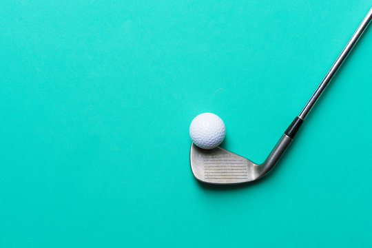 golf ball and golf club on green background