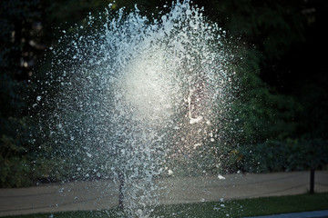 Water being forced into the air in front of blur background