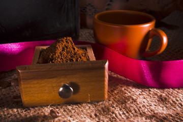 Ground coffee and ceramic cup