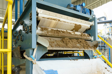 Black sludge disposal from wastewater treatment in white plastic bag