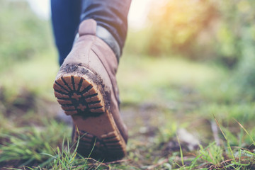 Shoes Man walking on a forest path in autumn and Lifestyle hiking concept.