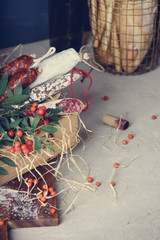 Fototapeta na wymiar Cured meats, bread and berries appetizer on a cutting board. Fall - winter