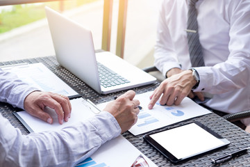 Business people discuss together about there work by graph document and setting in outdoor for planning financial strategy.