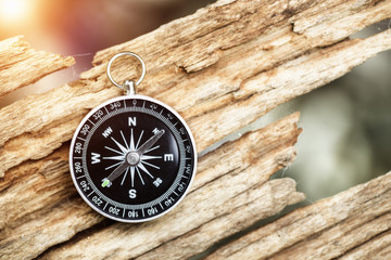 A magnetic compass on the old wood.Direction,Lost,searching, exploring concept. © PRIME STOCK LAB