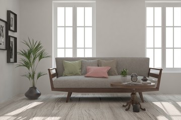 Fototapeta premium Idea of white minimalist room with sofa. Scandinavian interior design. 3D illustration