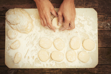 Woman making cheesecakes. Top view, closeup, flat lay.