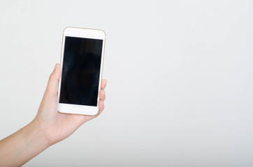 Woman hand holding smartphone with blank screen isolated on white background.