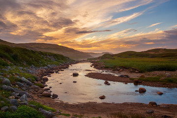 Fototapeta premium Sunset over the river in the tundra
