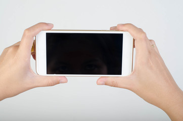 Woman hand holding smartphone with blank screen isolated on white background.
