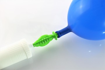 An image of a white air-pump inflating a blue balloon on a white background 