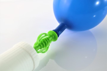 An image of a white air-pump inflating a blue balloon on a white background 