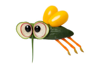 Fly made of cucumber and carrot on isolated background © serg78
